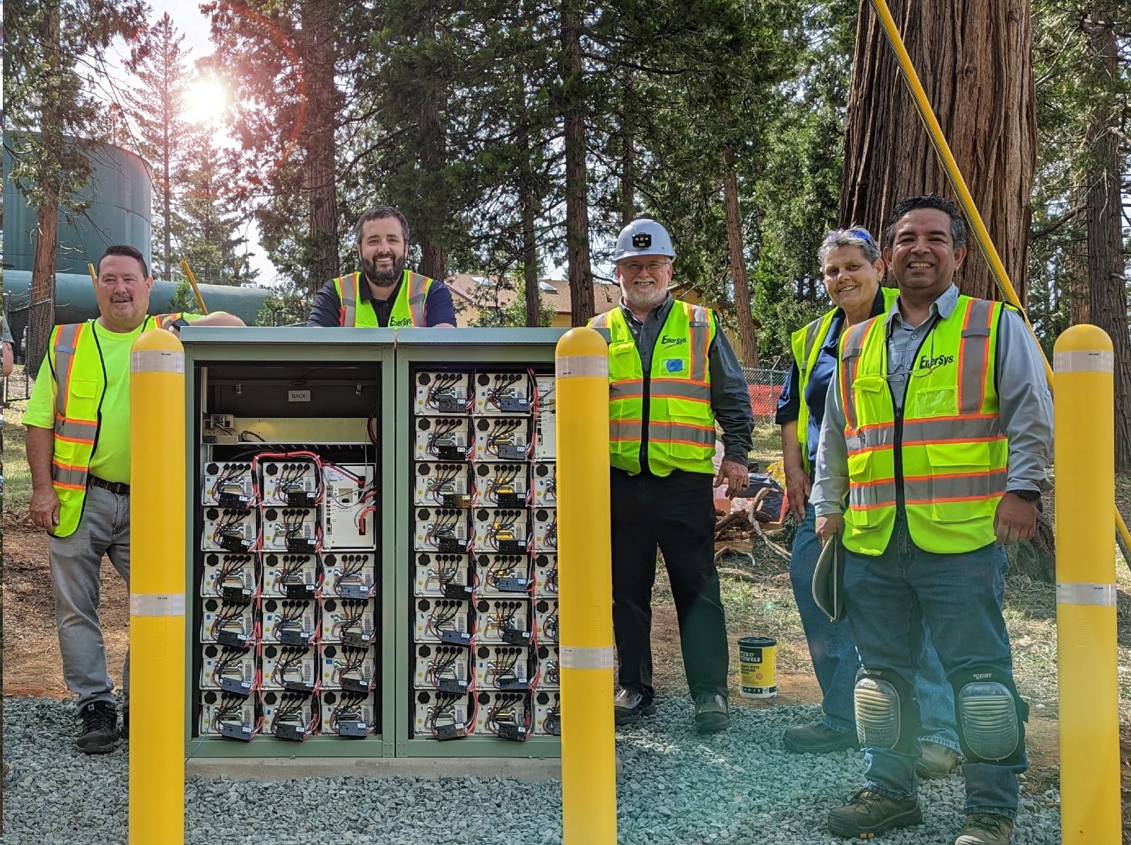 Men in High Viz standing in front of electrical cabinet